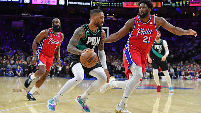 Portland Trail Blazers guard Damian Lillard drives to the basket against Philadelphia 76ers center Joel Embiid.